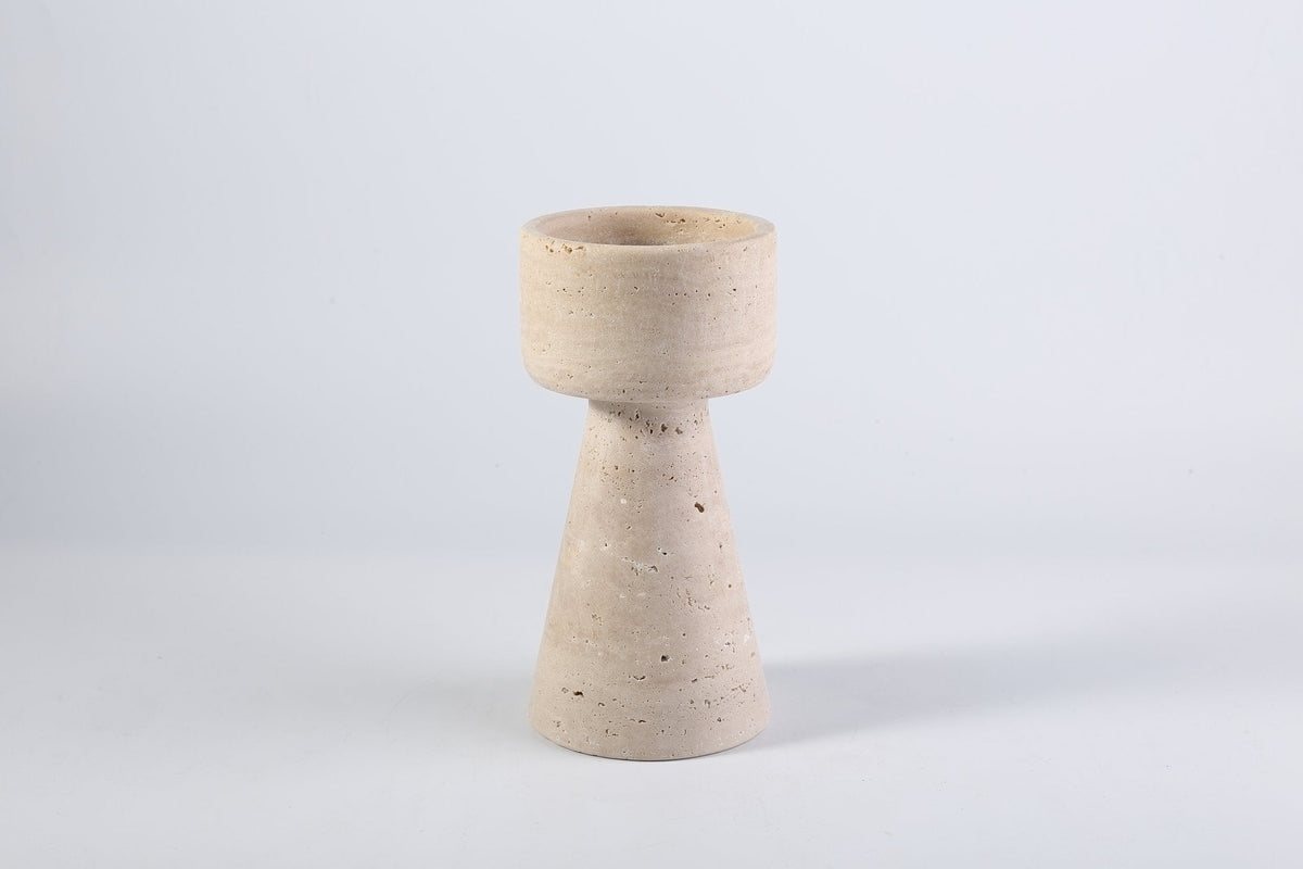 Koville candlestick in Light BeigeTravertine with a lit tea light candle