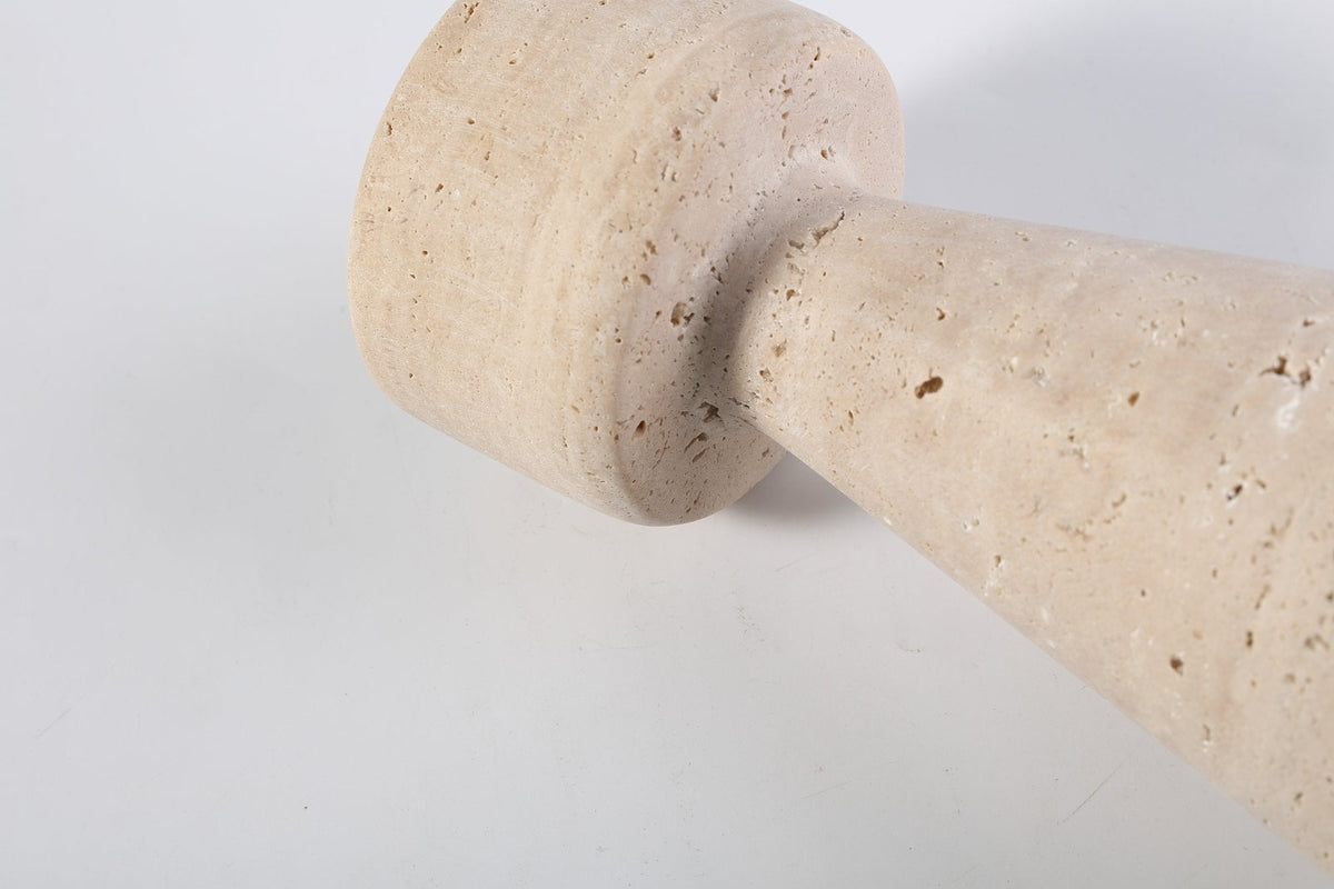 Koville candlestick in Light BeigeTravertine with a lit tea light candle