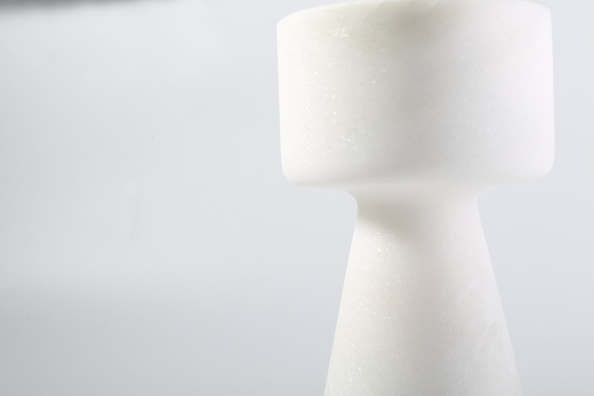 Koville natural marble lighthouse candle holder h 203 2 in Namib Bianco with a lit tea light candle