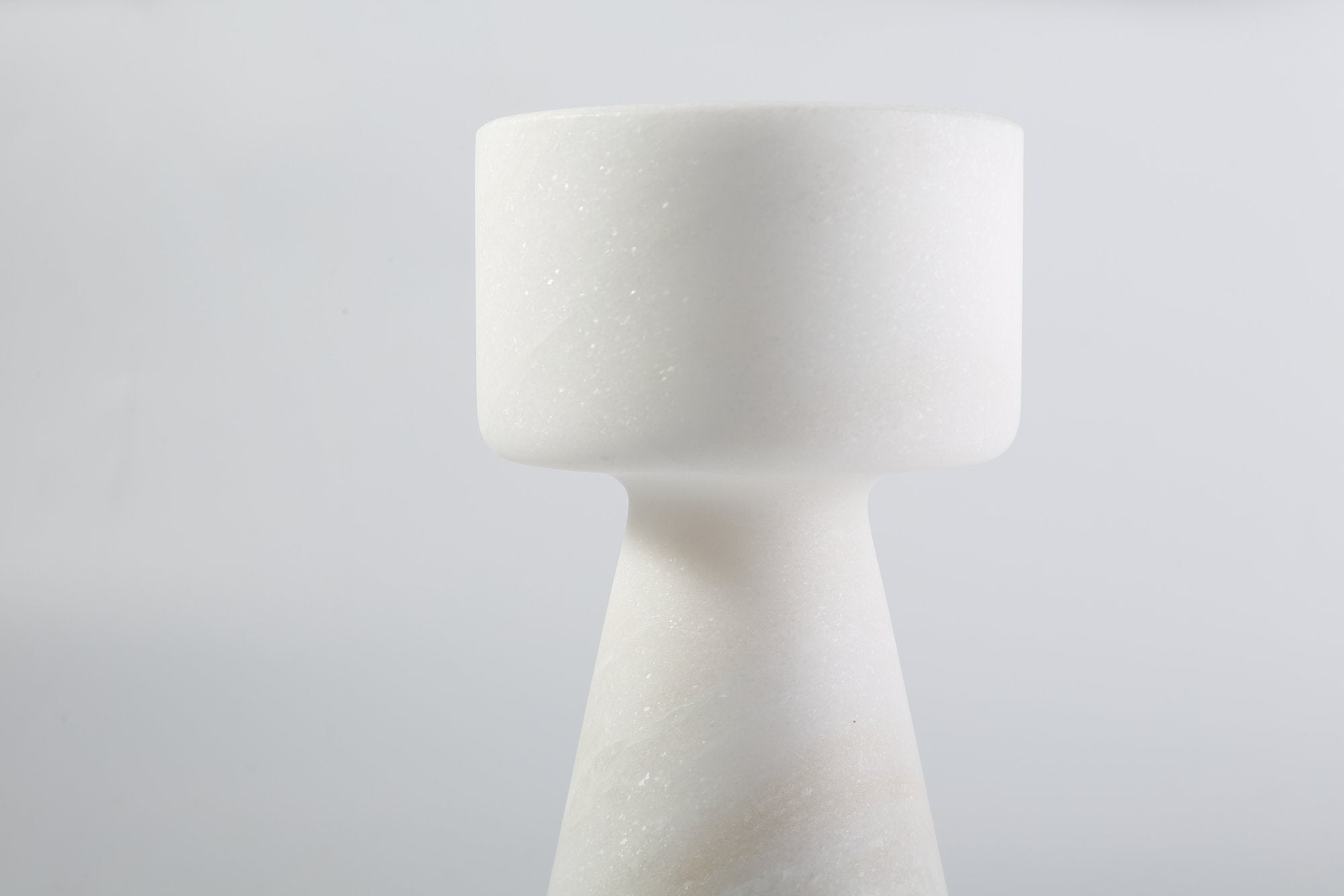 Koville natural marble lighthouse candle holder h 203 2 in Namib Bianco with a lit tea light candle