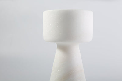 Koville candlestick in Namib Bianco with a lit tea light candle