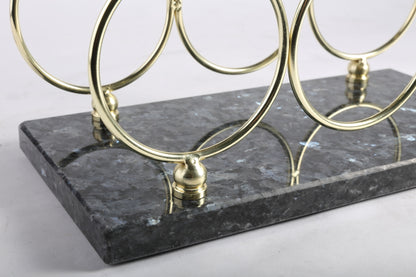 Koville Natural Stone Wine Rack in Blue Pearl on a kitchen counter holding wine bottles