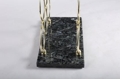 Koville Natural Stone Wine Rack in Blue Pearl on a kitchen counter holding wine bottles