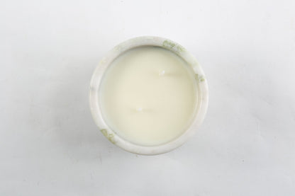 Koville natural marble scented candle d 110 in Bianco Palomino with a lit tea light candle
