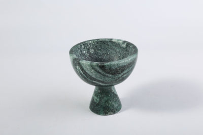 Koville storage cup in Verde Lapponia with lid on a vanity counter