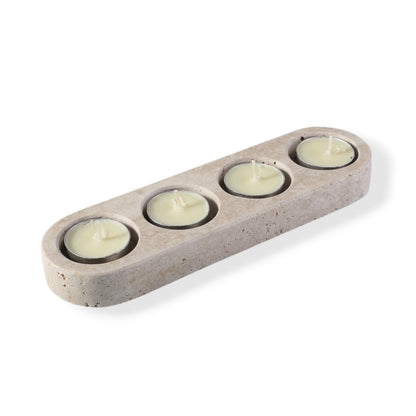 Koville natural marble tea light candle holder 4 holes in Travertino Romano with a lit tea light candle