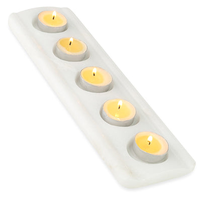 Koville tea light candle holder in Namib Bianco with a lit tea light candle