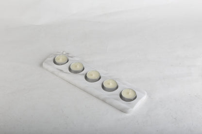 Koville natural marble tea light candle holder 5 holes in Namib Bianco with a lit tea light candle