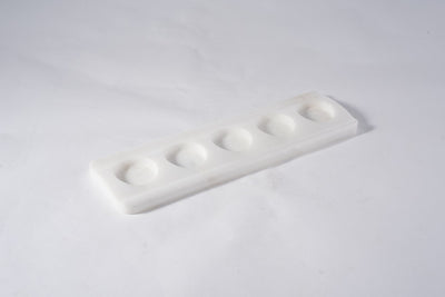 Koville tea light candle holder in Namib Bianco with a lit tea light candle