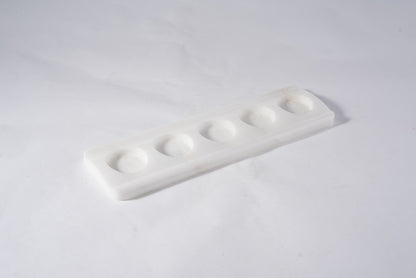 Koville natural marble tea light candle holder 5 holes in Namib Bianco with a lit tea light candle