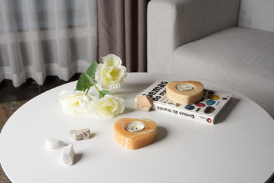 Koville tea light candle holder in Orange Onyx with a lit tea light candle