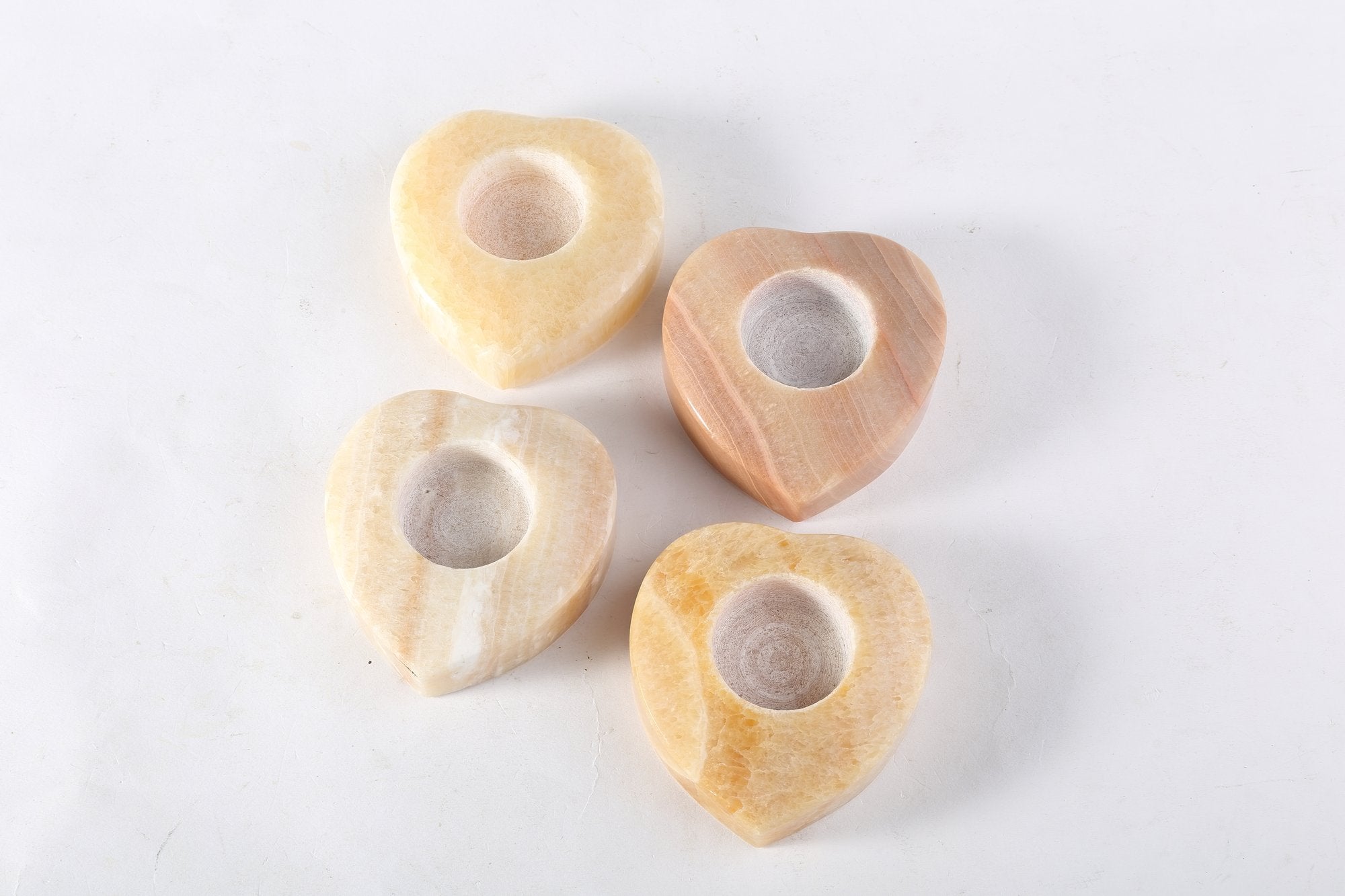 Koville natural marble tea light candle holder t 30 in Orange Onyx with a lit tea light candle