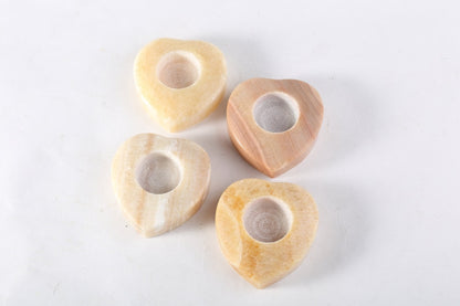 Koville natural marble tea light candle holder t 30 in Orange Onyx with a lit tea light candle