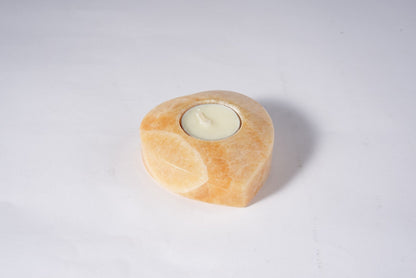Koville natural marble tea light candle holder t 30 in Orange Onyx with a lit tea light candle