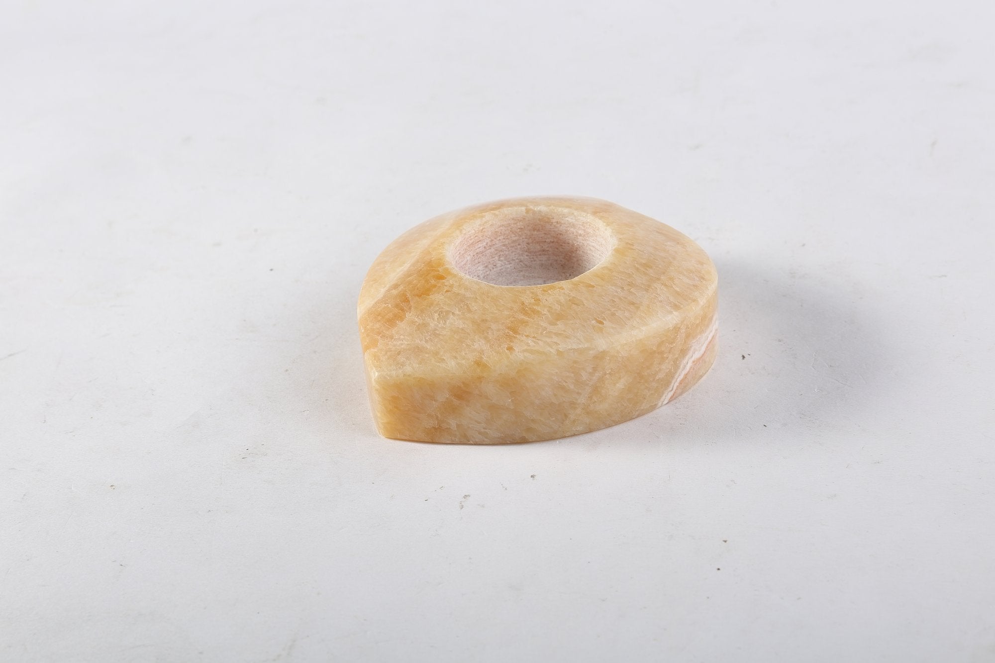 Koville natural marble tea light candle holder t 30 in Orange Onyx with a lit tea light candle