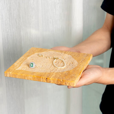 Koville natural stone bas relief tray in Golden Travertine - stone surface detail