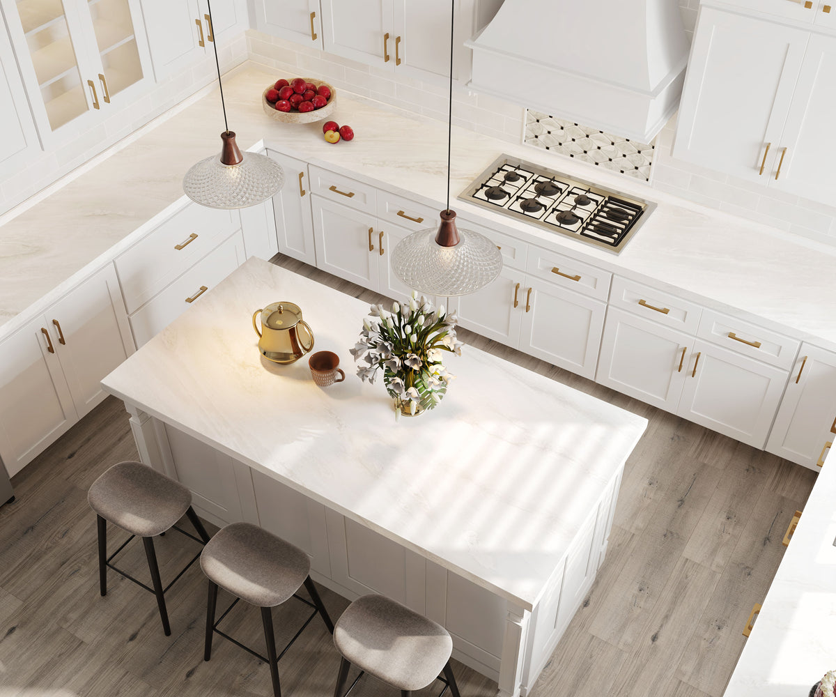Bright white kitchen with natural stone countertops and a marble-topped island.